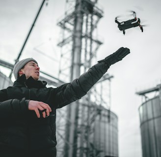 A farmer using a tablet to control a drone.