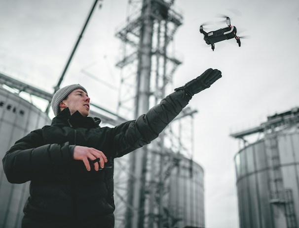 A farmer using a tablet to control a drone.