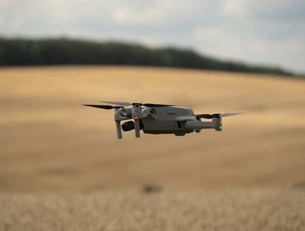 A farmer inspecting crops with a tablet, while a drone hovers nearby.
