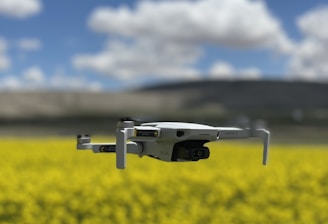 Close-up of a drone spraying crops in a sunny landscape.