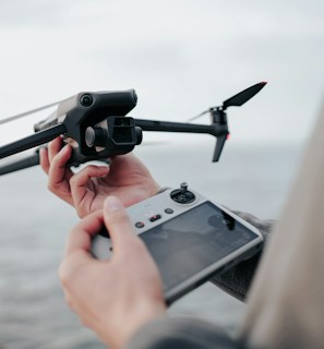 A technician operating a drone with a remote control.