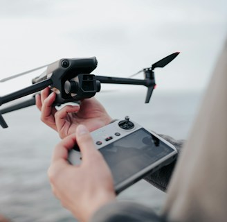 A technician operating a drone with a remote control.