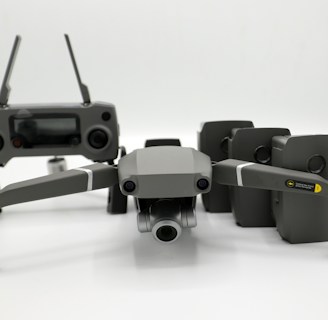 A group of drones lined up ready for deployment in a field.